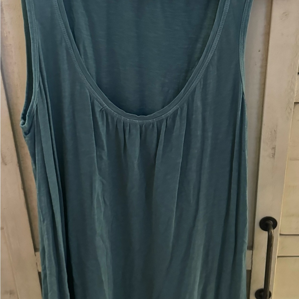 Light teal colored tank dress with swirl embellishments at hem line.